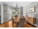 Inviting dining area with natural light from bay windows, hardwood floors, and elegant chandelier at 1498 Farrow Dr, Rock Hill, SC 29732