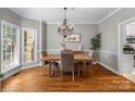 Dining room featuring hardwood floors, a modern chandelier, and a large window for natural light at 1498 Farrow Dr, Rock Hill, SC 29732