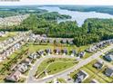 Aerial view showcases the property's location within a lakeside community surrounded by lush greenery and winding streets at 15429 Topanga Dr, Charlotte, NC 28278
