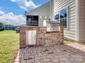 Outdoor brick kitchen island featuring a stainless steel grill, ideal for outdoor entertaining and summer barbecues at 15429 Topanga Dr, Charlotte, NC 28278