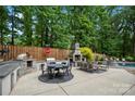 The outdoor kitchen and patio area, featuring a pizza oven, dining area, fireplace, and seating at 19507 Dufour Ct, Cornelius, NC 28031