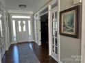 Welcoming foyer with hardwood floors, elegant trim, and bright natural light at 20107 N Cove Rd, Cornelius, NC 28031