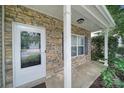 Inviting front porch with stone detailing around a front door with glass and a white pillar at 2117 Seabrook Ln, Fort Mill, SC 29715