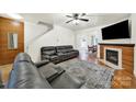 Spacious living room featuring hardwood floors, a cozy fireplace, and ample seating space at 2117 Seabrook Ln, Fort Mill, SC 29715