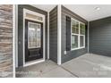 Elegant front door with glass insert complementing the home's stylish exterior and dark shutters at 2232 Tabor Rd # 570, Sherrills Ford, NC 28673
