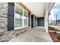 Inviting front porch featuring stone accents, sturdy columns, and a smooth concrete floor at 2232 Tabor Rd # 570, Sherrills Ford, NC 28673