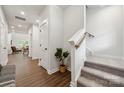 Bright entryway features hardwood floors, carpeted stairs, and modern finishes at 3042 Finchborough Ct # 235, Charlotte, NC 28269