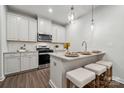This modern kitchen features white cabinets, granite countertops, and stainless steel appliances at 3042 Finchborough Ct # 235, Charlotte, NC 28269