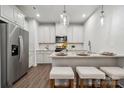 This modern kitchen features white cabinets, granite countertops, and stainless steel appliances at 3042 Finchborough Ct # 235, Charlotte, NC 28269