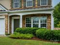 Close-up of front entrance featuring stone facade, well maintained landscaping and classic architecture at 3224 Dunbar Ln, Fort Mill, SC 29707