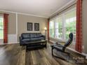 Well-lit living room featuring modern furniture, and large windows at 3224 Dunbar Ln, Fort Mill, SC 29707