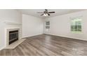 Spacious living room with a fireplace, modern flooring, and large windows offering natural light at 3312 James Rd, Charlotte, NC 28215