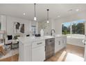 Open kitchen with quartz countertops, stainless steel appliances, and a view into the living area at 3314 & 3316 Cedarhurst Dr, Charlotte, NC 28269