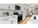 Modern kitchen with stainless steel appliances, white subway tile backsplash, and light wood floors at 3314 & 3316 Cedarhurst Dr, Charlotte, NC 28269