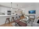 Bright open-concept living room with a large island, stainless appliances and views of the dining area at 3314 & 3316 Cedarhurst Dr, Charlotte, NC 28269