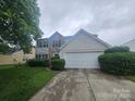 Charming two-story home with a stone-accented facade and a well-manicured front yard at 3912 Laurel View Cir, Indian Trail, NC 28079