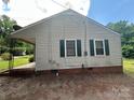 This home has vinyl siding, green shutters, and a covered back porch at 407 Lincoln St, Wadesboro, NC 28170