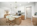 Bright eat-in kitchen with stainless appliances, a large island and modern pendant lighting at 4547 Kings Ct, Hickory, NC 28602
