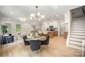 Open-concept living area with dining table and chairs, bright windows and hardwood floors at 4547 Kings Ct, Hickory, NC 28602