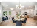 Open-concept living area with dining table and chairs, bright windows and hardwood floors at 4547 Kings Ct, Hickory, NC 28602