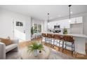 Open-concept kitchen featuring a large island with seating, white cabinets, and stainless steel appliances at 4815 & 4817 Victoria Dr, Charlotte, NC 28269