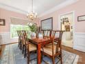 Formal dining room with a large table, chandelier, and access to the kitchen at 5417 Bedfordshire Ave, Harrisburg, NC 28075