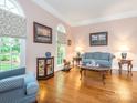 Bright living room with hardwood floors, large windows, and elegant furnishings at 5417 Bedfordshire Ave, Harrisburg, NC 28075