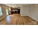Open concept kitchen and living space featuring wood floors and stainless appliances at 5823 Natick Dr, Charlotte, NC 28214
