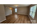Open floor plan showcasing wood floors and natural light through large windows at 5823 Natick Dr, Charlotte, NC 28214