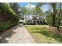 Beautiful two-story home with a well-manicured lawn, a detached garage, and a long driveway at 5910 Grosner Pl, Charlotte, NC 28211