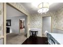 Charming dining area with decorative wallpaper, elegant lighting, and wood floors at 709 Plantation Rd, Lancaster, SC 29720