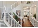 Spacious foyer featuring hardwood floors, staircase, and views into other living areas at 7833 Taymouth Ln, Charlotte, NC 28269