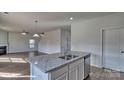 Open-concept kitchen with granite countertops overlooking the spacious living area at 820 Candy Dr, Statesville, NC 28677