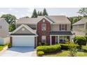 Charming two-story home with red shutters, brick accents, and a well-manicured front lawn at 10815 Mountain Springs Dr, Charlotte, NC 28278