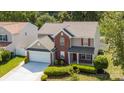 Inviting two-story home featuring a two-car garage, manicured lawn, and traditional architectural details at 10815 Mountain Springs Dr, Charlotte, NC 28278