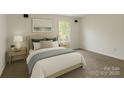 Comfortable bedroom with neutral tones, carpet, and natural light from a window at 1401 Woodman Hall St, Shelby, NC 28152