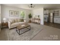 Bright living room with neutral tones, modern furniture, and open kitchen view at 1401 Woodman Hall St, Shelby, NC 28152
