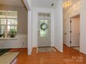 Light-filled foyer featuring hardwood floors, decorative door, and neutral wall paint at 14336 Northridge Dr, Charlotte, NC 28269