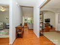 Open hallway with hardwood floors offering views into the living room and other spaces at 14336 Northridge Dr, Charlotte, NC 28269