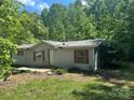 Cozy home with red shutters presents a traditional façade in a wooded, secluded location at 156 Hurst Dr, Statesville, NC 28677