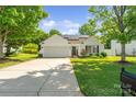Well-maintained home with a lush front lawn and solar panels on a sunny day at 1961 Leesburg Dr, Clover, SC 29710