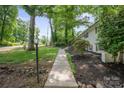 Exterior of the home featuring a well-maintained yard and a walkway leading to the entrance at 218 Kingsway Cir, Charlotte, NC 28214