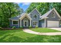 Charming exterior elevation with manicured lawn, arched windows, and inviting entrance at 26056 Neptunes Lndg, Fort Mill, SC 29708