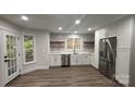 Bright, updated kitchen with white cabinets, stainless steel appliances, and wood grain vinyl floors at 26056 Neptunes Lndg, Fort Mill, SC 29708