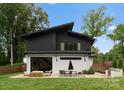 Chic backyard featuring an outdoor dining set, lounge area, and a built-in barbecue at 2913 Lake Ave, Charlotte, NC 28208