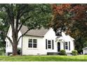 A cozy home with a white exterior, complemented by dark shutters and landscaping at 330 17Th Nw St, Hickory, NC 28601
