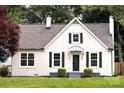 Home featuring a well-maintained lawn, crisp white exterior, black shutters and door at 330 17Th Nw St, Hickory, NC 28601