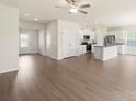 Open-concept living space with hardwood floors and a modern, all-white kitchen at 3331 Burberry Dr, Gastonia, NC 28052