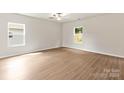 Spacious bedroom with wood flooring and natural light from two large windows at 3334 Strong Box Ln, Gastonia, NC 28052