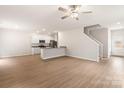 Open-concept living space with wood floors, recessed lights, and eat-in kitchen area at 3334 Strong Box Ln, Gastonia, NC 28052